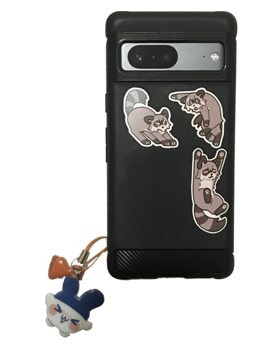 A black rugged Google Pixel 7 with a puffy Mimitchi keychain